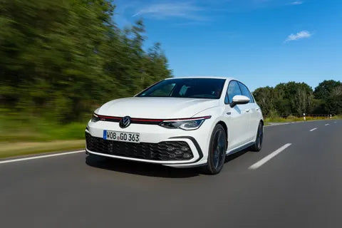 european performance parts on dark steel workbench with dramatic rim lighting