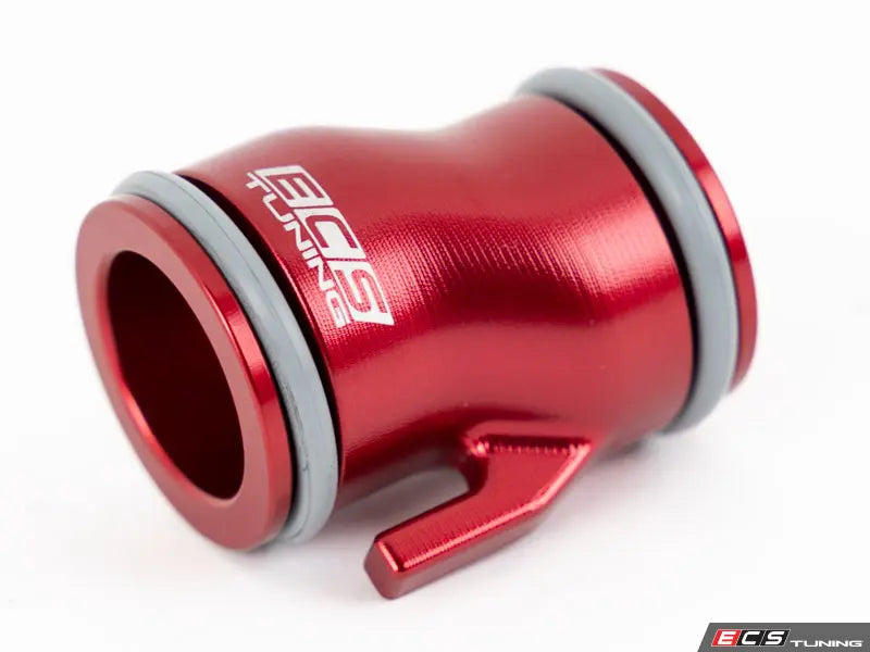 Red metal fitting with branding on a white background