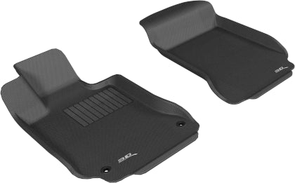 Two black car floor mats on a white background